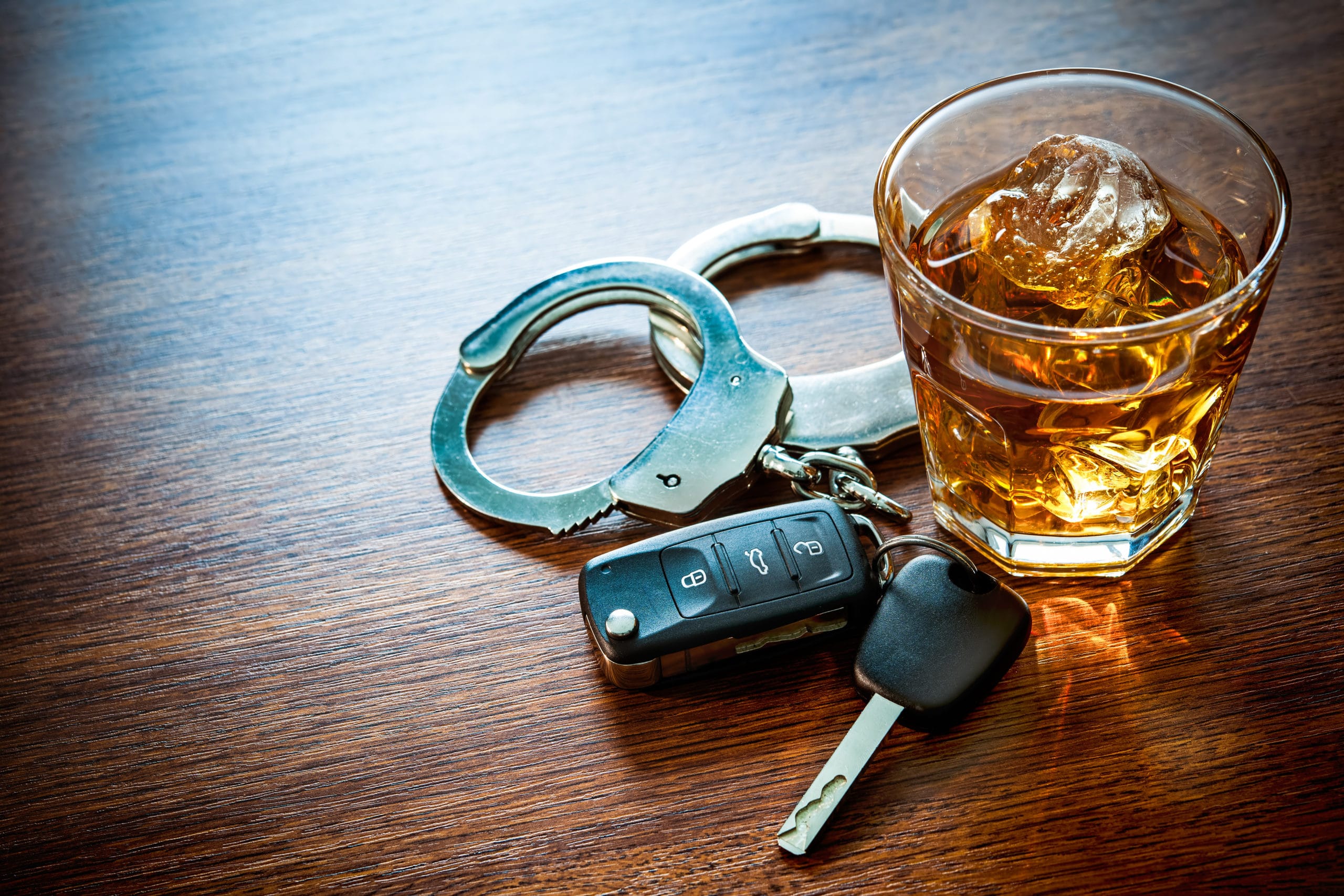 vehicular manslaughter sentence with image of drink, car keys, and handcuffs